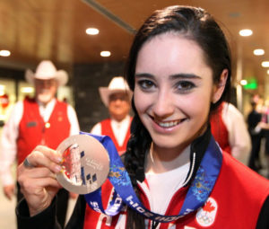 Colleen De Neve/ Calgary Herald CALGARY, AB --FEBRUARY 25, 2014 -- Canadian figure skater Kaetlyn Osmond showed off her silver medal for the team skating competition as she arrived at the Calgary International Airport on February 24, 2014. (Colleen De Neve/Calgary Herald) (For City story by Val Fortney) 00053199A SLUG: OLY RETURNEES